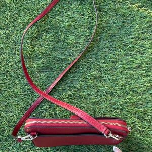 Luxury deep bright red Kate Spade bag, with strap and three compartments